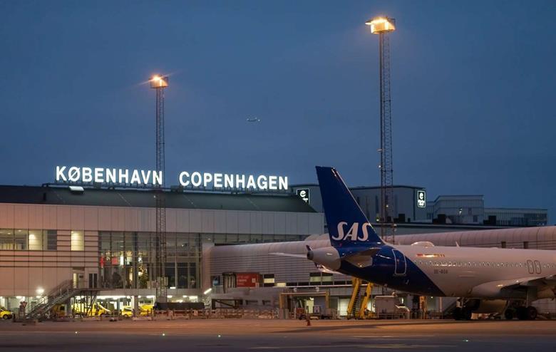 SAS aircraft in front of Copenhagen Airport at night