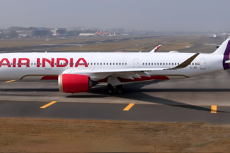 A sleek white Air India Airbus A350-900 taxis along a runway at an airport.