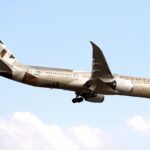 Etihad Airways Boeing 787-9 flying under a blue sky