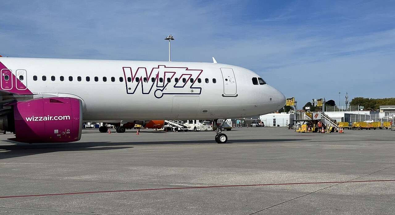 The front of a Wizz Air aircraft parked on the ground.