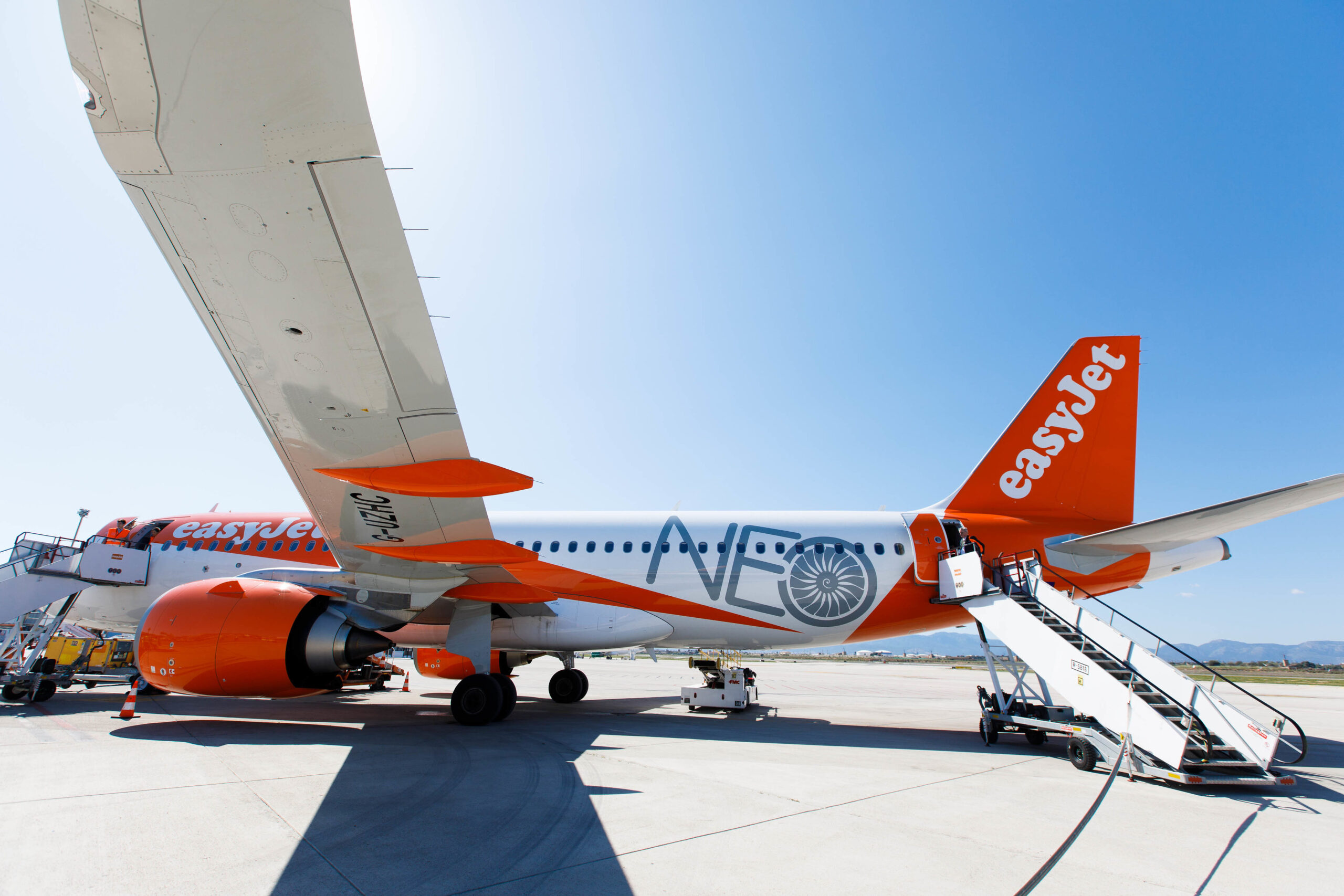 easyJet Airbus A320neo aircraft on the tarmac, stairs leading up to the plane.