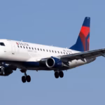 A Delta Airlines aircraft amid blue skies in flight.