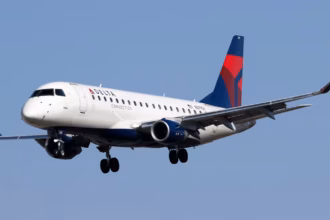 A Delta Airlines aircraft amid blue skies in flight.