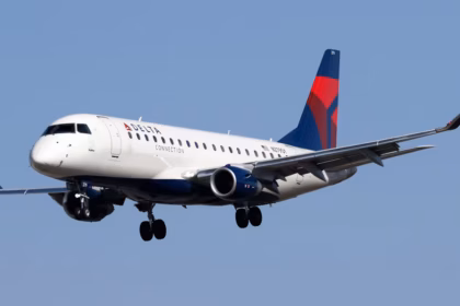 A Delta Airlines aircraft amid blue skies in flight.