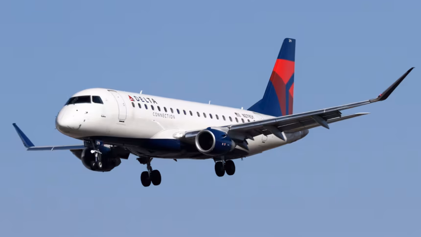 A Delta Airlines aircraft amid blue skies in flight.