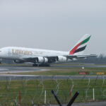 Emirates Lands at Manchester Airport, with grey skies in the background the Emirates bright logo standing out.