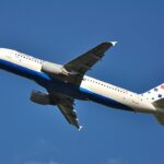 This low-angle shot captures a Croatia Airlines Airbus A320-214 (registration 9A-CTK) climbing steeply into a clear, deep blue sky after takeoff.