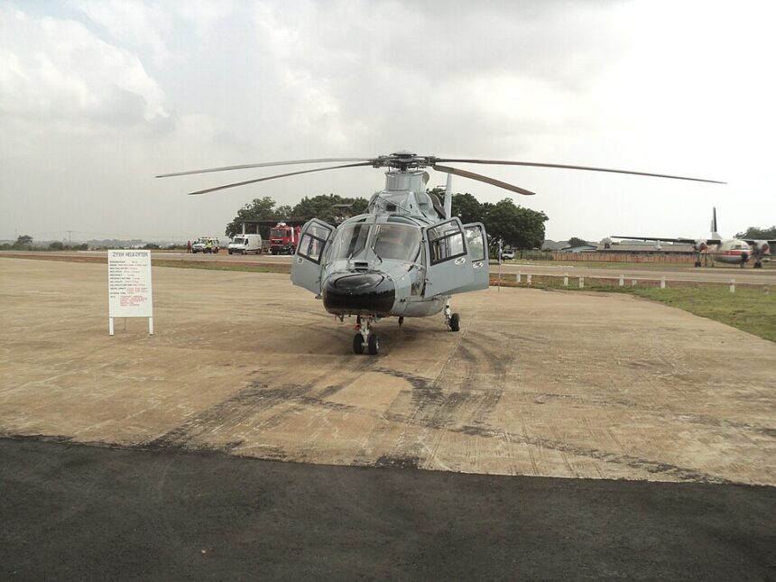 A head-on view of a light grey Harbin Z-9EH military helicopter parked on a tarmac under an overcast sky.