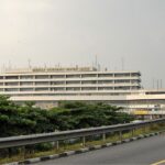 External view of the Murtala Muhammed International Airport (LOS) terminal in Lagos, Nigeria, under a hazy sky