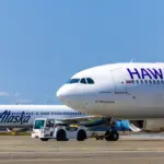 A picture of two planes, Alaska and Hawaiian Airlines