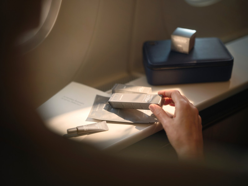Passenger looks at the BABOR amenity kit products served at Lufthansa FOX First Class