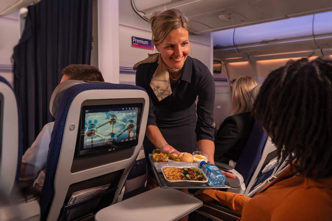A stewardess serving an African-inspired dish in Business Class