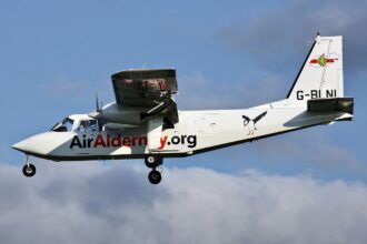 Air Alderney plane mid air photographed from the side.