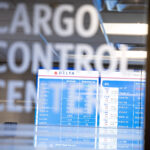 The Cargo Control Centre at Delta, with a departures board visible through the glass.
