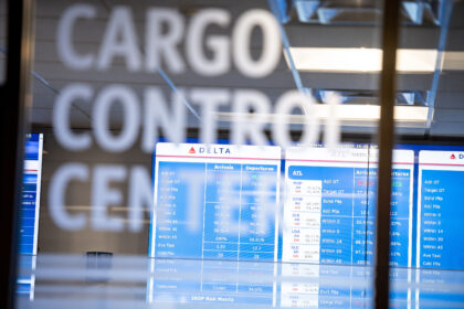 The Cargo Control Centre at Delta, with a departures board visible through the glass.