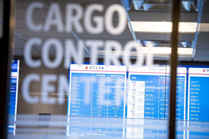 The Cargo Control Centre at Delta, with a departures board visible through the glass.