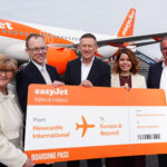 easyJet representatives with a large boarding pass labelled 'From Newcastle to Europe and beyond'