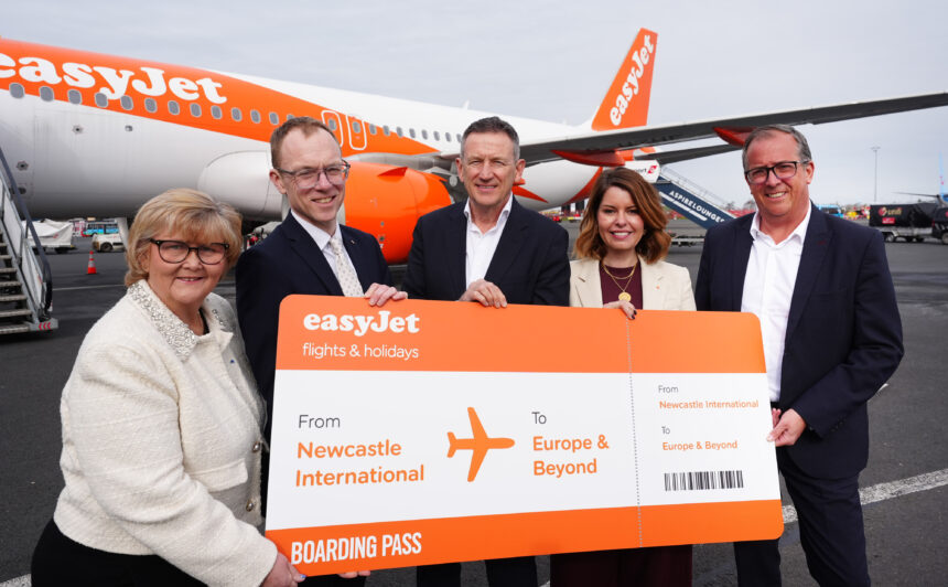easyJet representatives with a large boarding pass labelled 'From Newcastle to Europe and beyond'