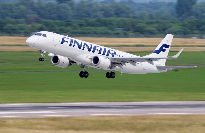 Embraer Finnair aircraft taking off. Blue and white livery.