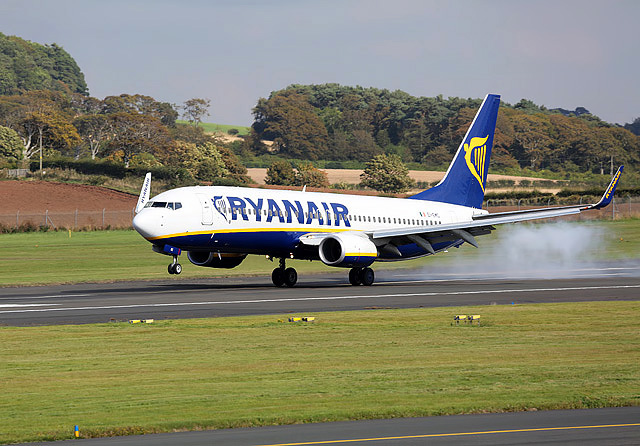 A Ryanair Boeing 737 aircraft touches down on a runway