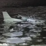 The Cessna 172 submerged in the Hudson River amid ice.