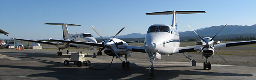 King Air 350 aircraft parked, blue sky in background.