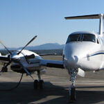 King Air 350 aircraft parked, blue sky in background.