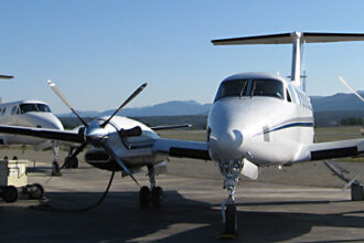 King Air 350 aircraft parked, blue sky in background.