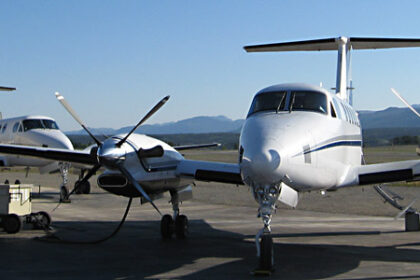 King Air 350 aircraft parked, blue sky in background.
