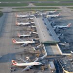 Aerial view of Heathrow Airport Terminal 5 in London. Numerous British Airways aircraft are parked at the gates