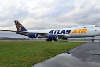 Atlas Air Boeing 747-8F on the runway surrounded by grass.