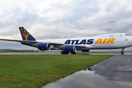 Atlas Air Boeing 747-8F on the runway surrounded by grass.