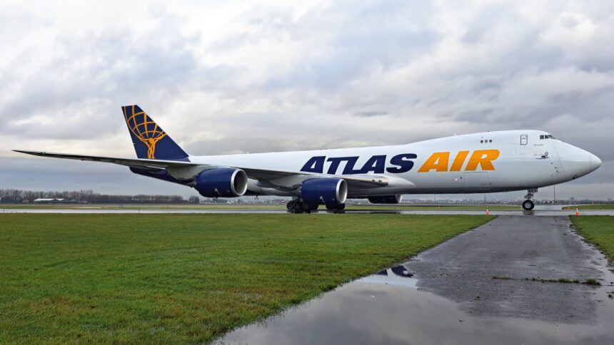 Atlas Air Boeing 747-8F on the runway surrounded by grass.