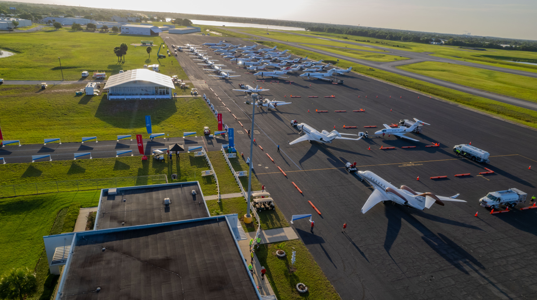 Exterior of Special Olympics Airlift, aircraft on tarmac, grass in the background.
