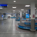 An empty airport baggage claim area with conveyor belts