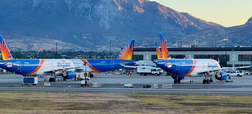 Three large jetliners waiting at an airport