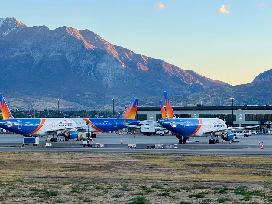 Three large jetliners waiting at an airport