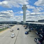 Cars queue at O'Hare terminal drop-off as FAA proposes flight cuts affecting passengers.