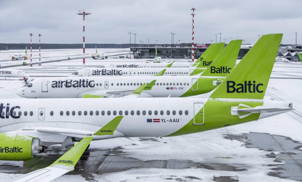 airBaltic fleet stationed on a runway