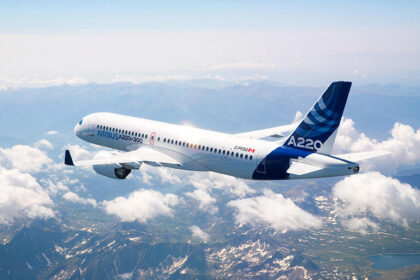 Airbus stretched A220 aircraft, flying through the clouds.