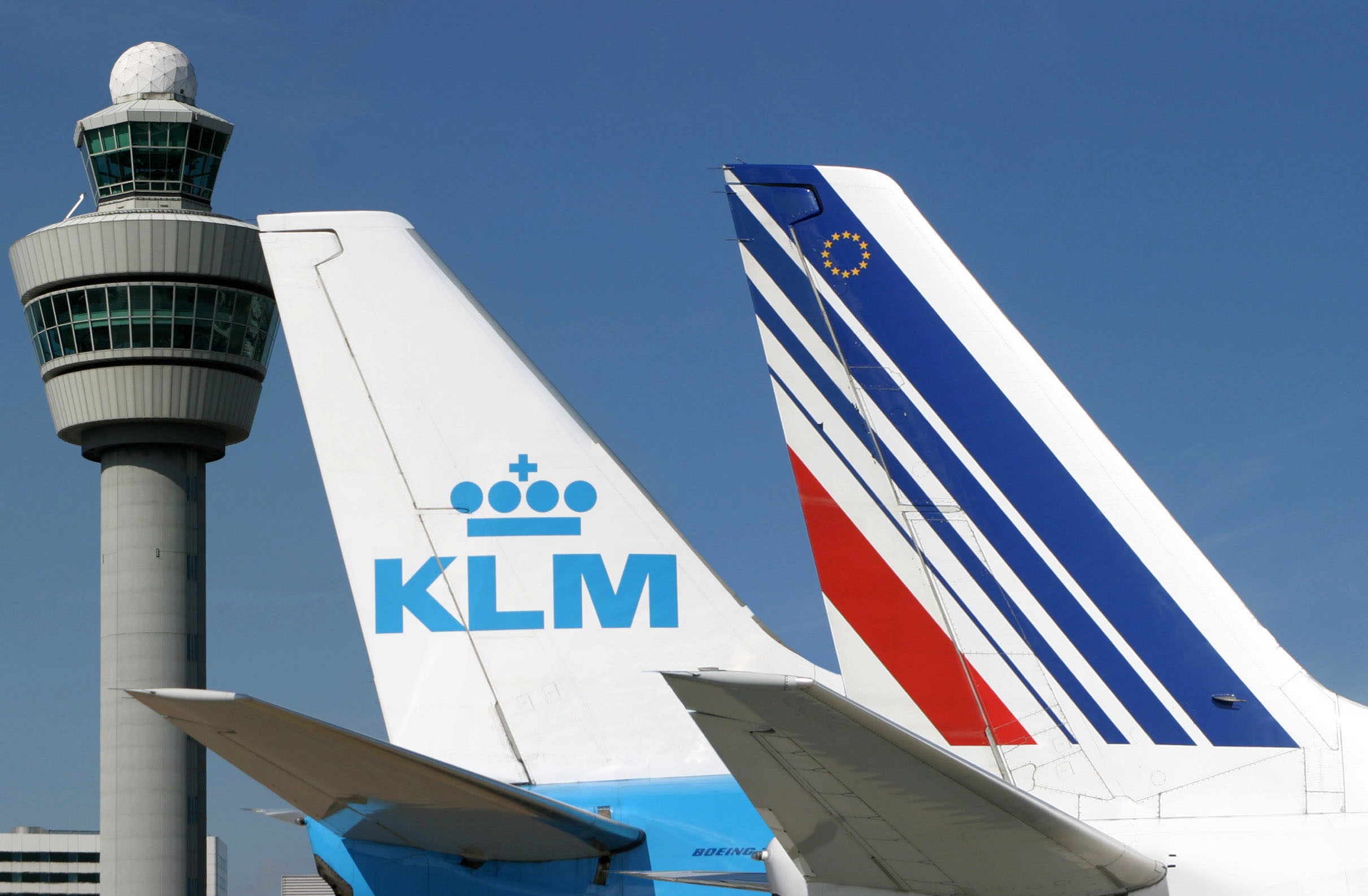 KLM and Air France aircraft tail fins with ATC tower in background