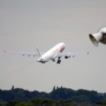 A large white plane taking off at an airport.