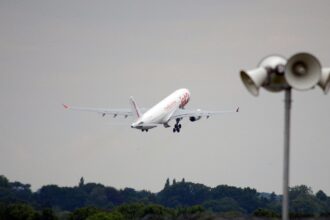 A large white plane taking off at an airport.
