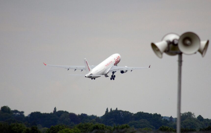 A large white plane taking off at an airport.