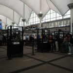 Queue at security checkpoint, inside building.