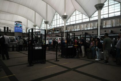 Queue at security checkpoint, inside building.