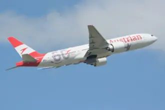 Austrian Airlines Boeing 777-20ER taking off on blue sky