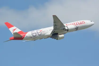 Austrian Airlines Boeing 777-20ER taking off on blue sky
