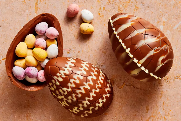 Image of two big chocolate Easter eggs with lots of multicoloured mini eggs inside.