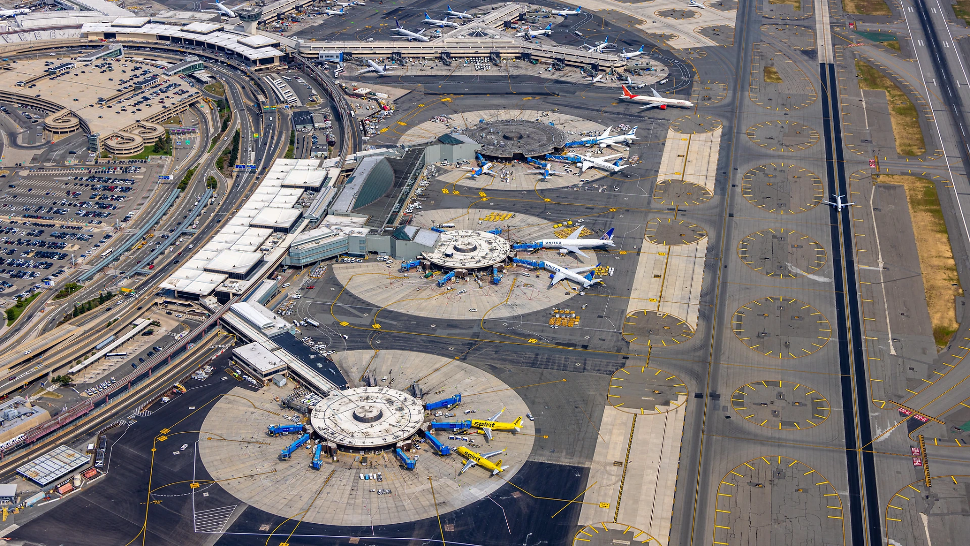 An image of Newark Airport from a bird's eye view, planes inside large circles.